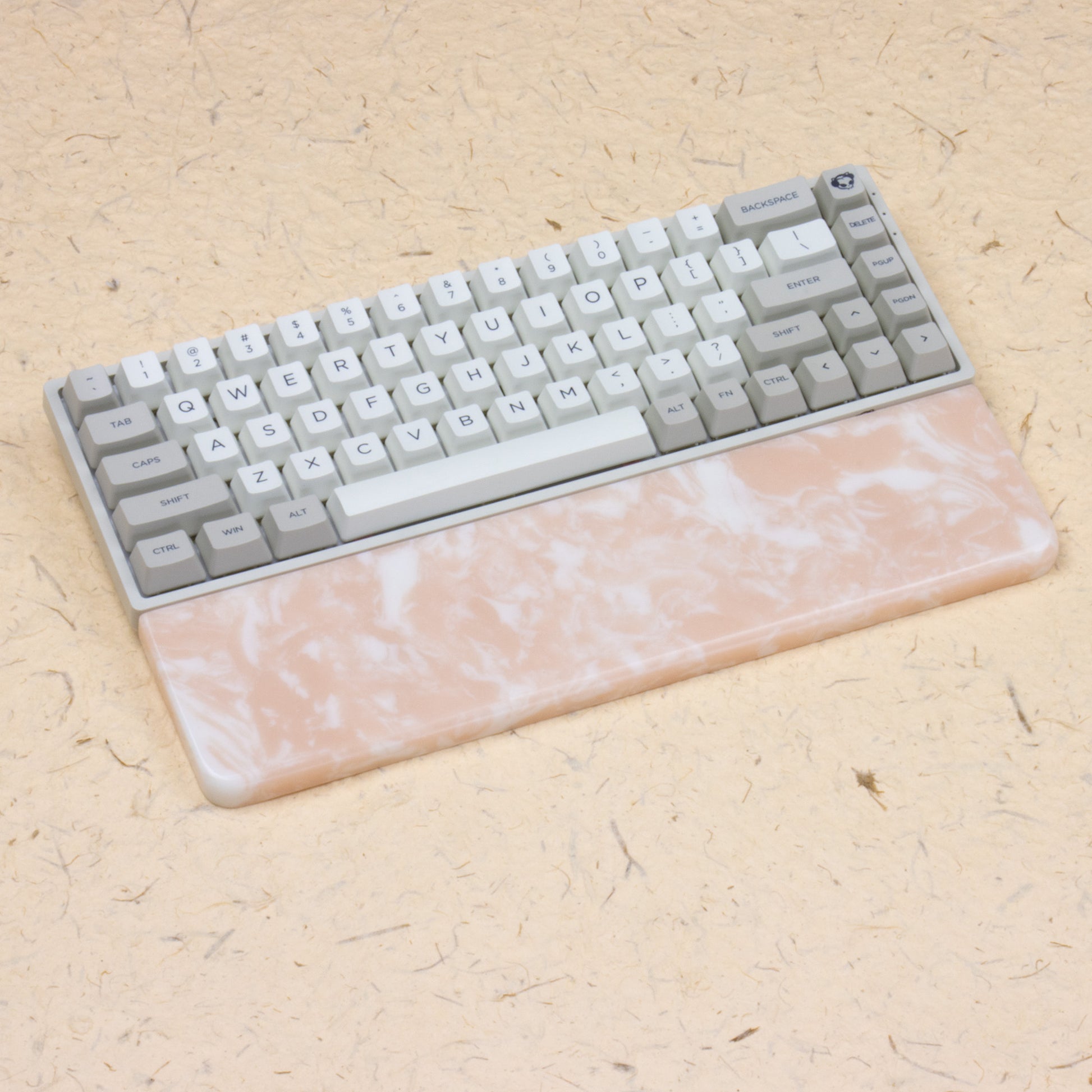 Pink resin wrist rest with keyboards