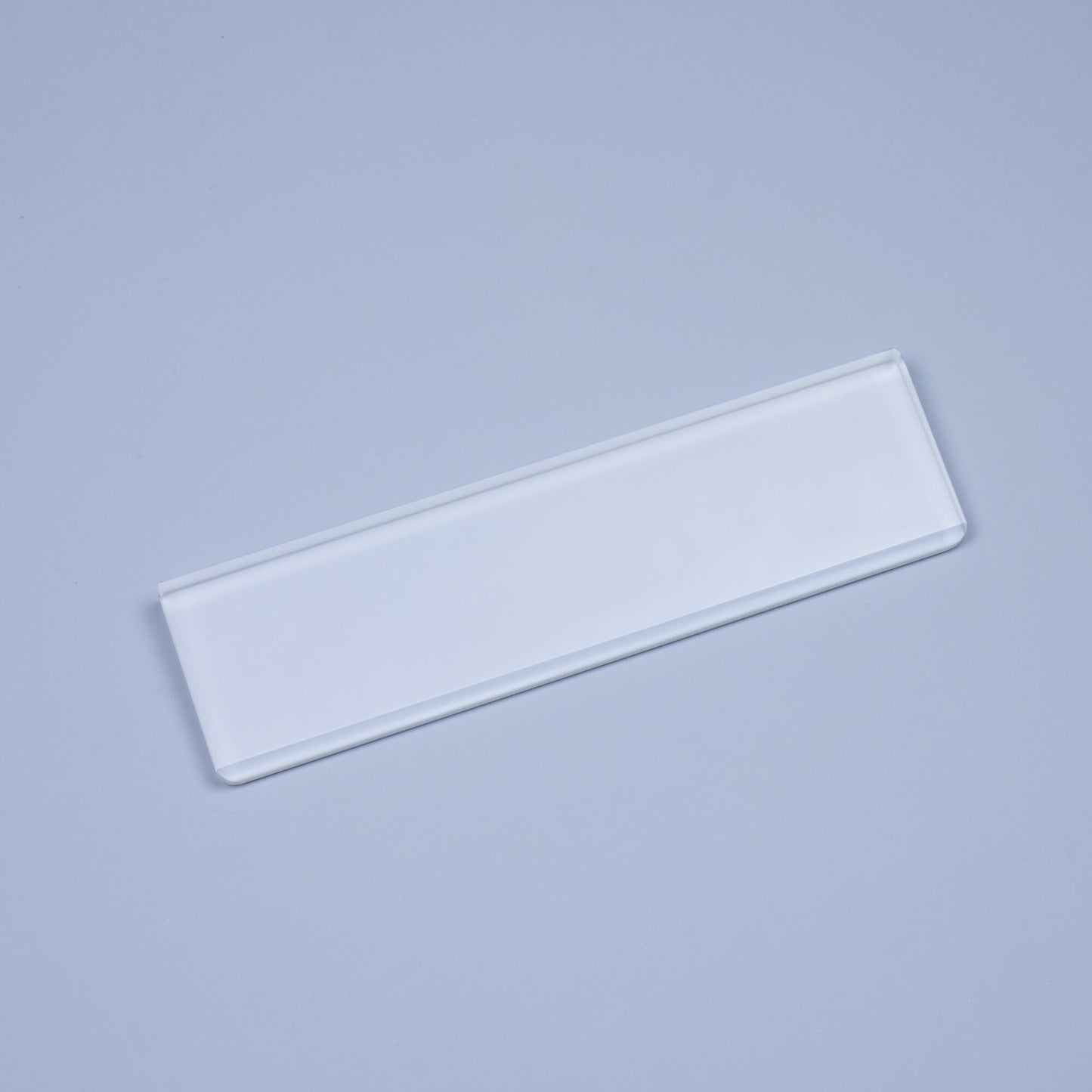 Side of Frosted Crystal Wrist Rest on blue background