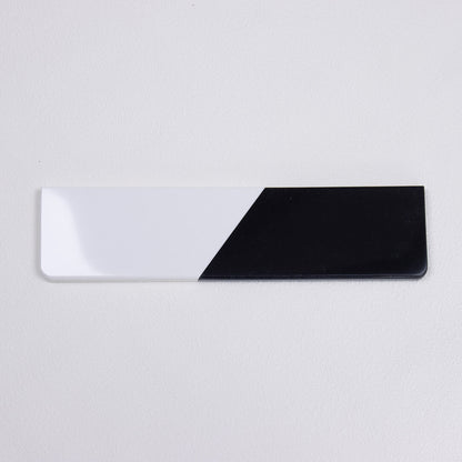 yeswristrest Pure Dual-Tone quartz stone wrist rest with solid black and white diagonal split isolated view