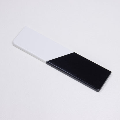 Angled profile shot of yeswristrest Pure Dual-Tone quartz wrist rest showcasing rounded corners and seamless solid diagonal split