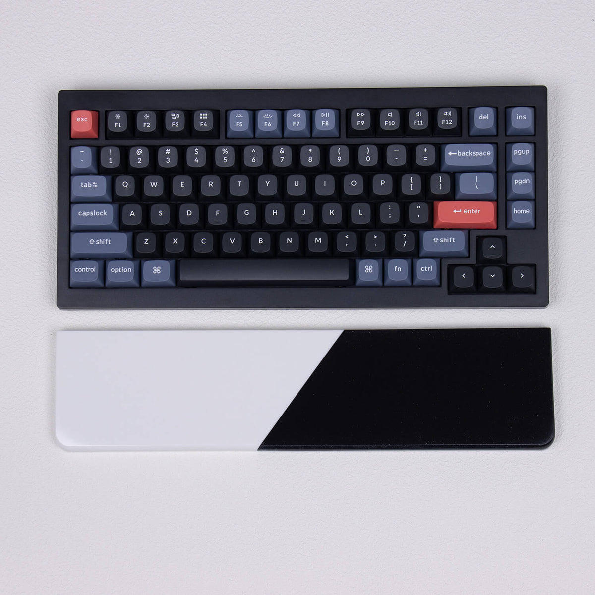 Top-down view of solid black and white Pure Dual-Tone quartz stone palm rest aligned with mechanical keyboard