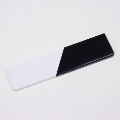 Perspective angle view of isolated Pure Dual-Tone solid black and white quartz stone wrist rest