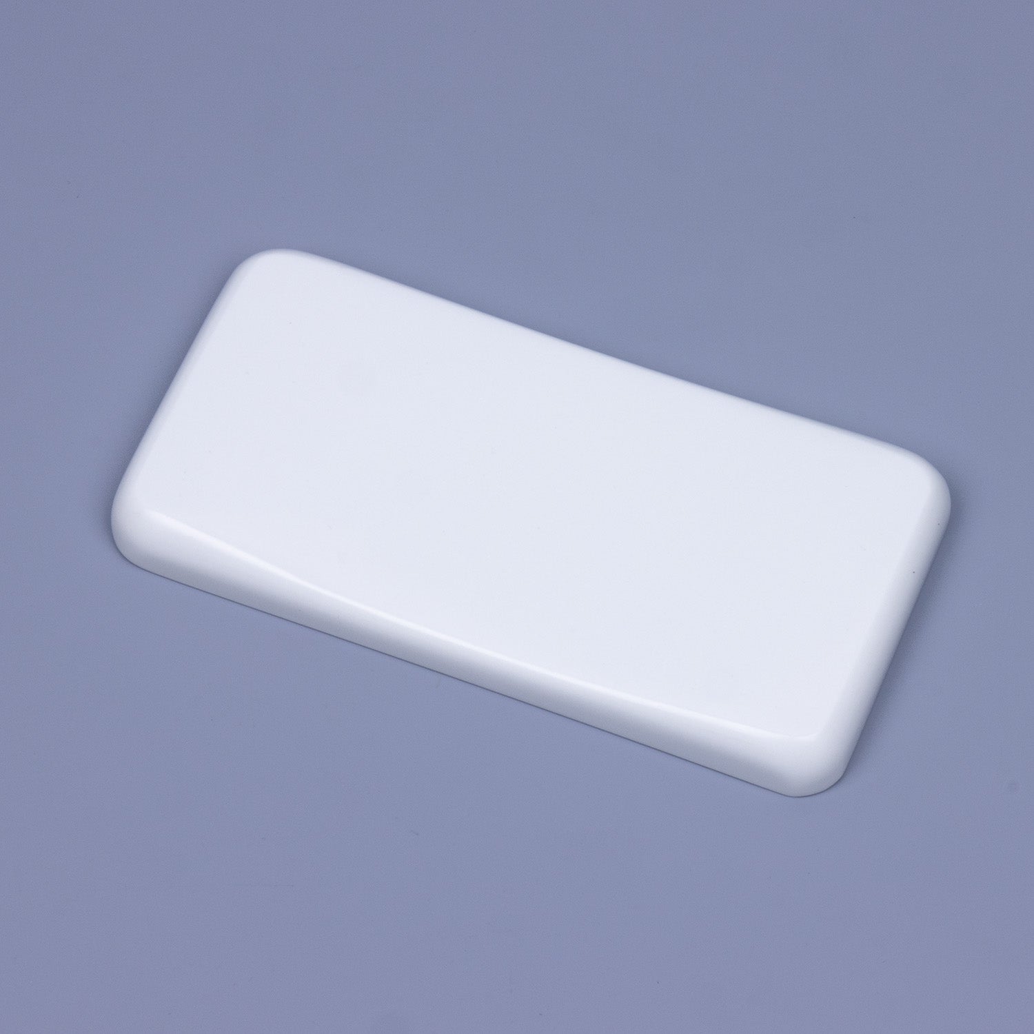 Angled close-up of a minimalist solid pure white quartz mouse wrist rest showing sleek polished chamfered edges and ergonomic sloped contour