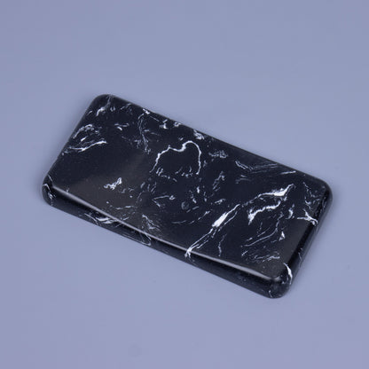 Angled top view of a premium black veil quartz mouse wrist rest with organic white marble veining and a smooth sloped ergonomic design
