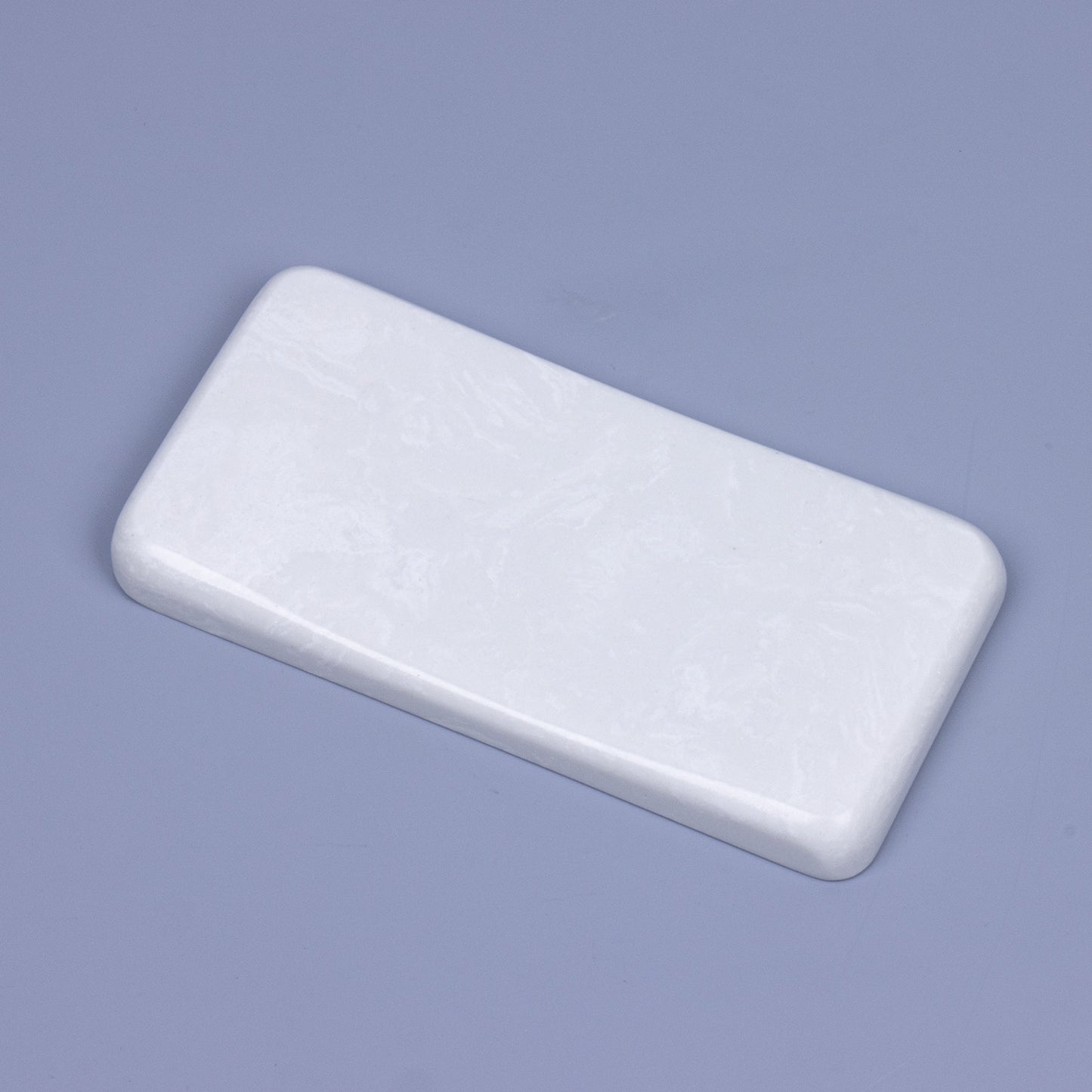 Side view showing the sleek ergonomic curved slope of a solid quartz mouse wrist rest