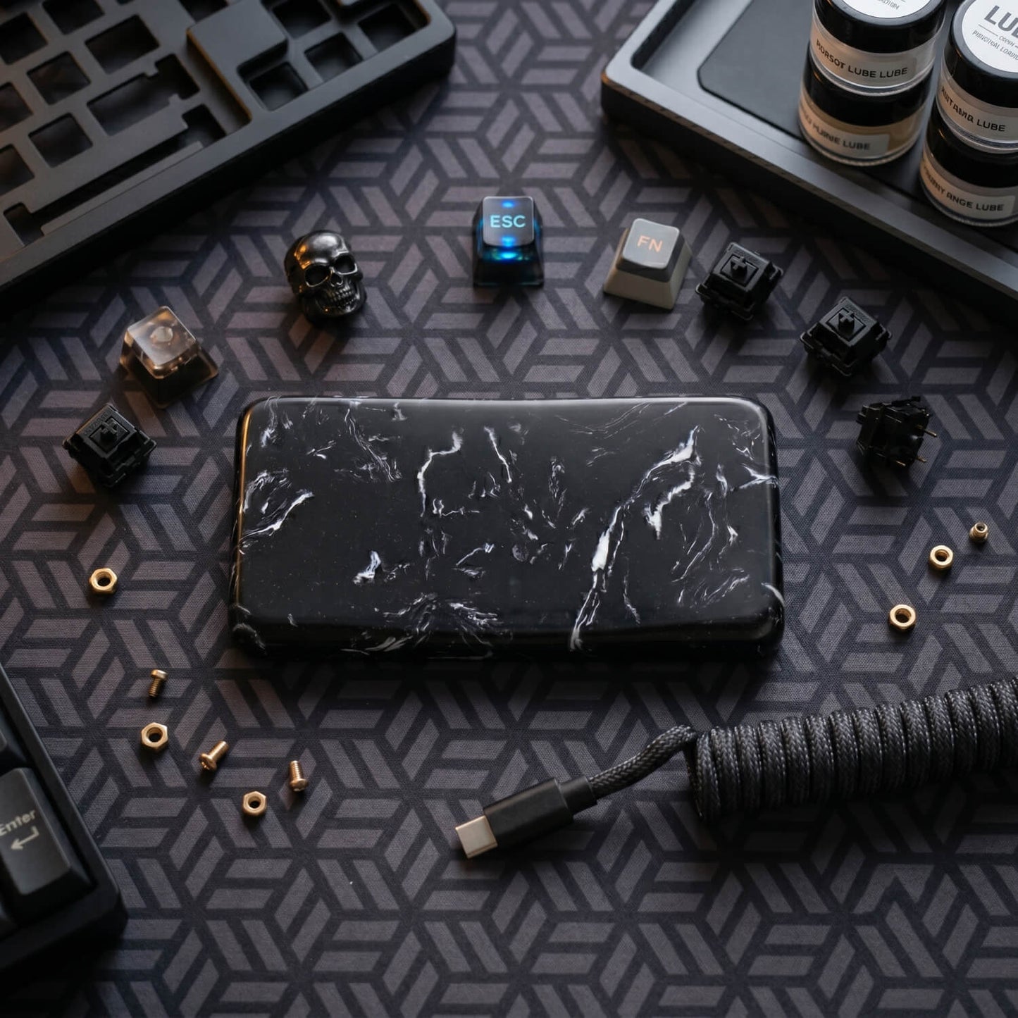 Premium black marble quartz mouse wrist rest styled on a custom mechanical keyboard desk setup with aviator cable