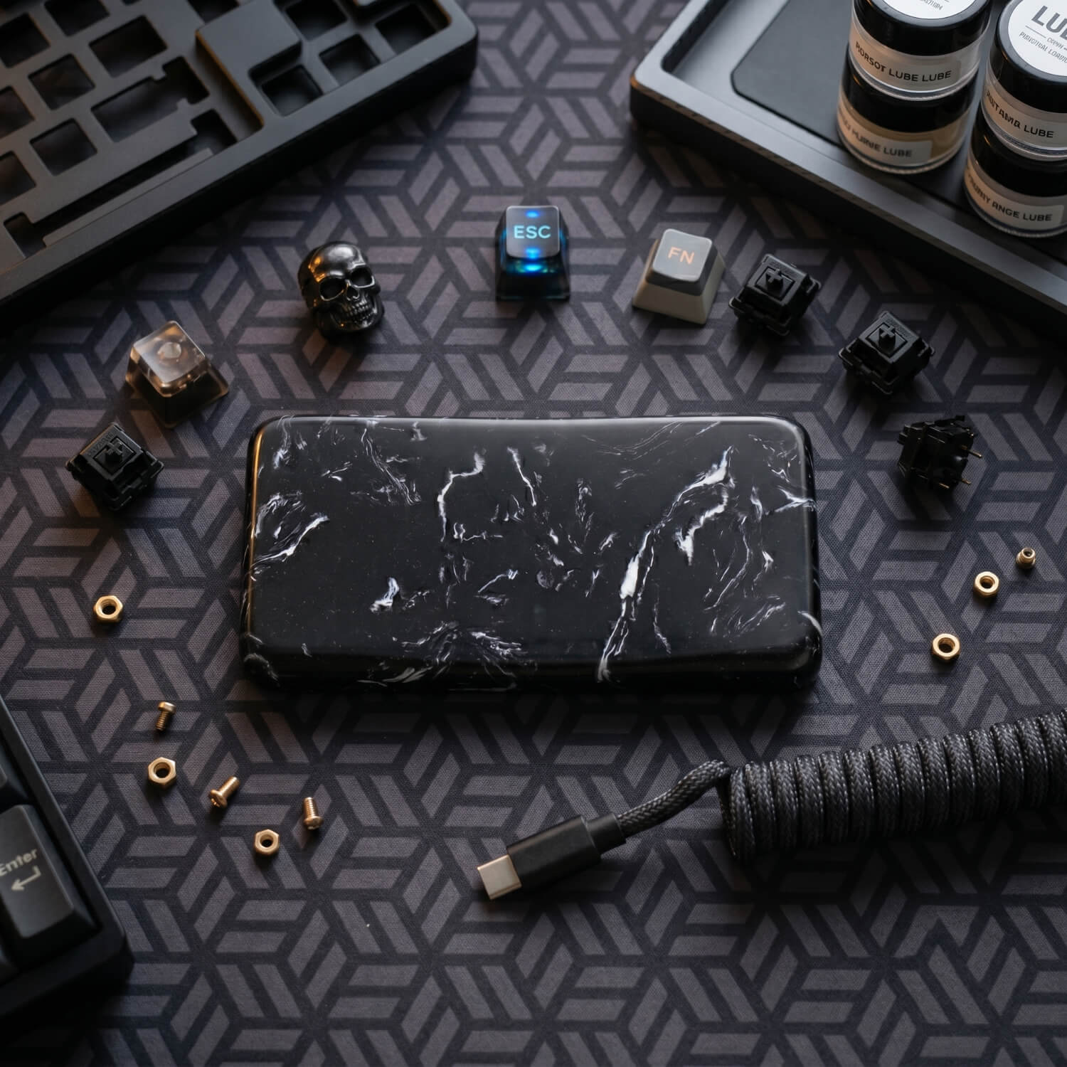 Premium black marble quartz mouse wrist rest styled on a custom mechanical keyboard desk setup with aviator cable