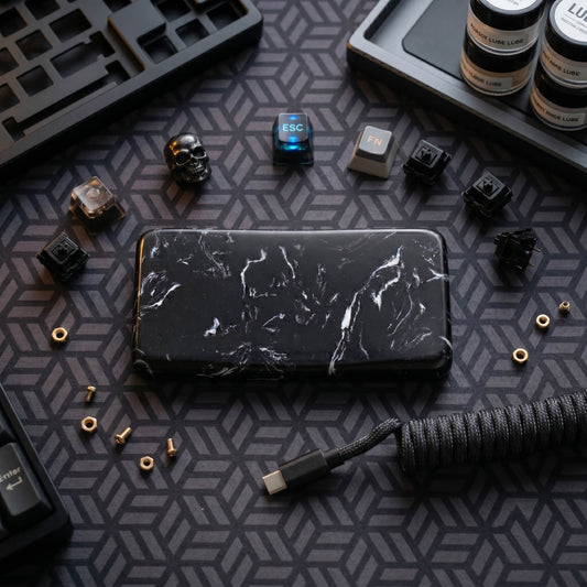 Premium black marble quartz mouse wrist rest styled on a custom mechanical keyboard desk setup with aviator cable